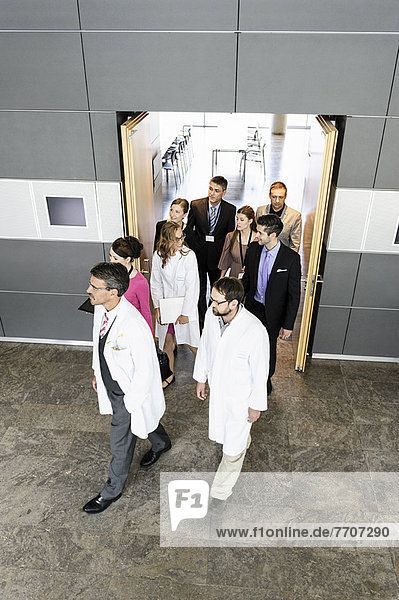 Business people and doctors in doorway