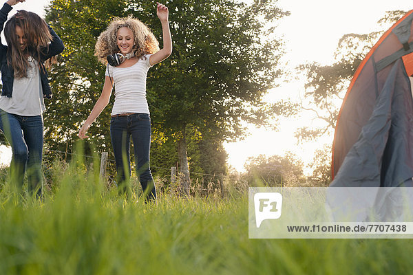 Teenage girls dancing in field