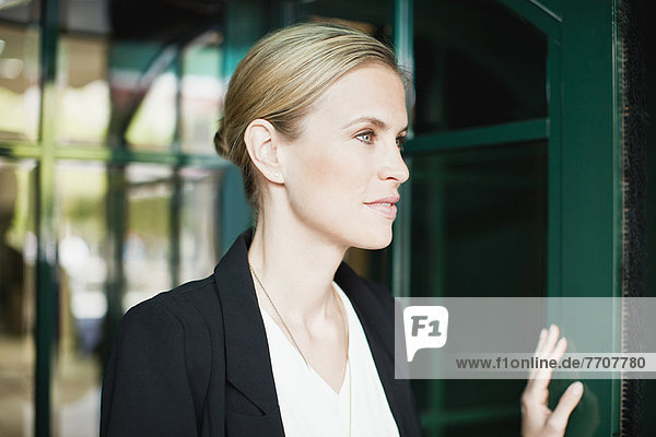 Businesswoman walking through doorway