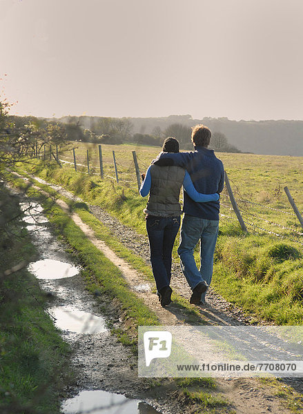Couple walking on rural road