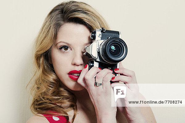 Woman taking pictures with vintage camera