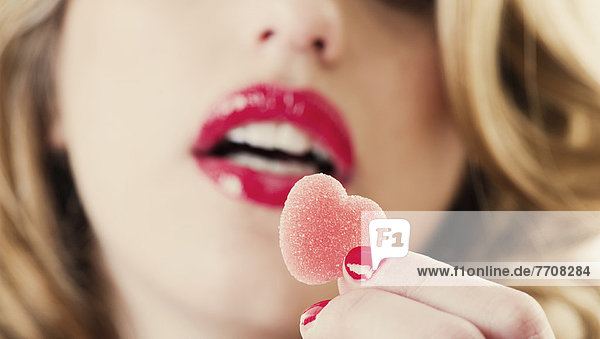 Close up of woman holding gummy candy