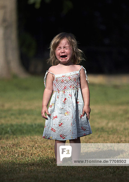 Girl crying in backyard