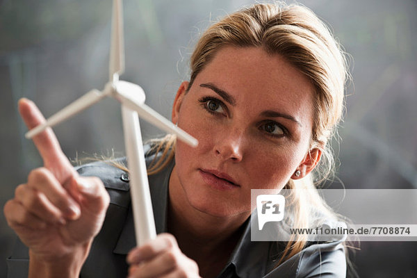 Woman with model wind turbine