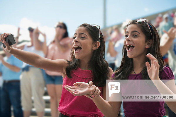 Two excited girls at a pop concert