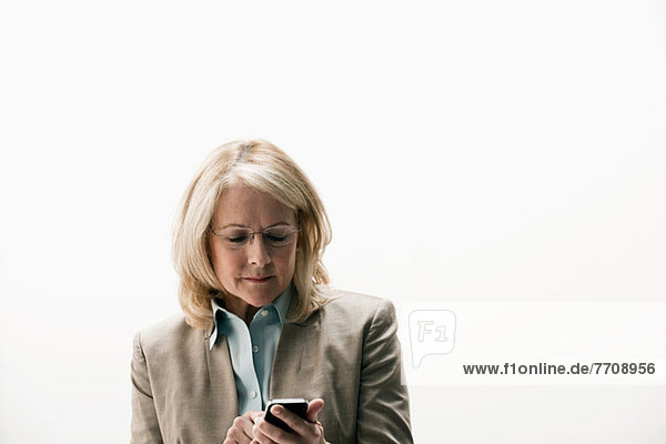 Businesswoman texting on smartphone