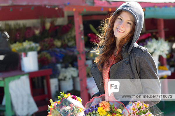 Woman buying flowers at florist