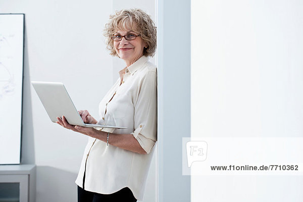 Businesswoman using laptop in office