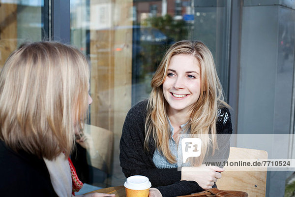 Women having coffee together outdoors