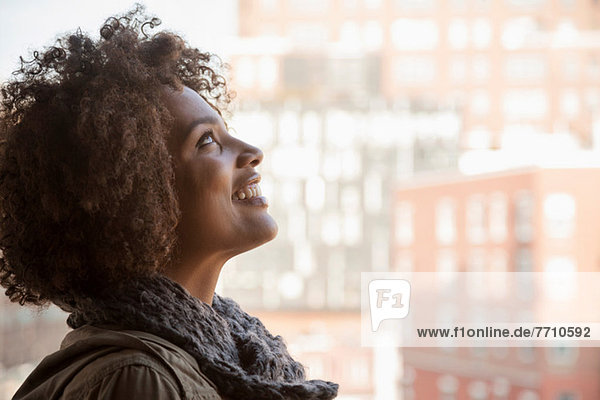 Smiling woman standing at window
