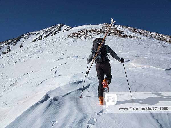 Cross country skier hiking up slope