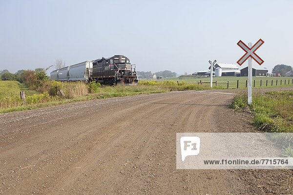 Shortline freight train at crossing  cheltenham ontario canada