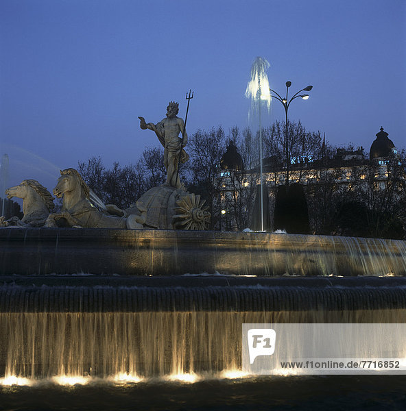 Neptune Fountain And Ritz Hotel Illuminated At Dusk