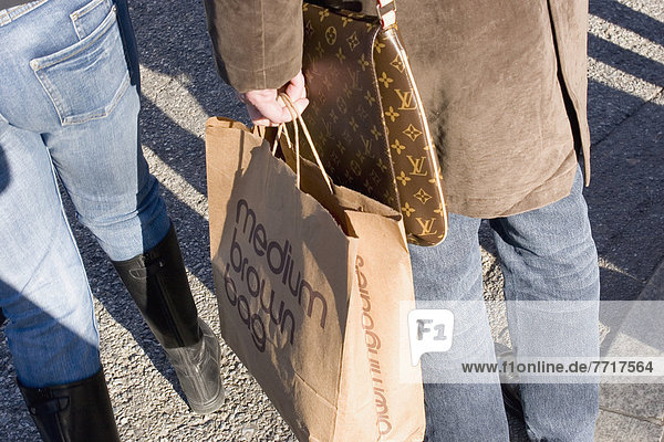 Woman Carrying Paper Shopping Bag