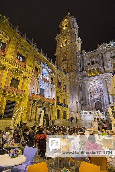 People At Cafe Tables In Square In Front Of Cathedral And Palacio Episcopal At Night  Malaga  Andalucia  Spain