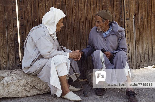 Elderly Men Talking On Street