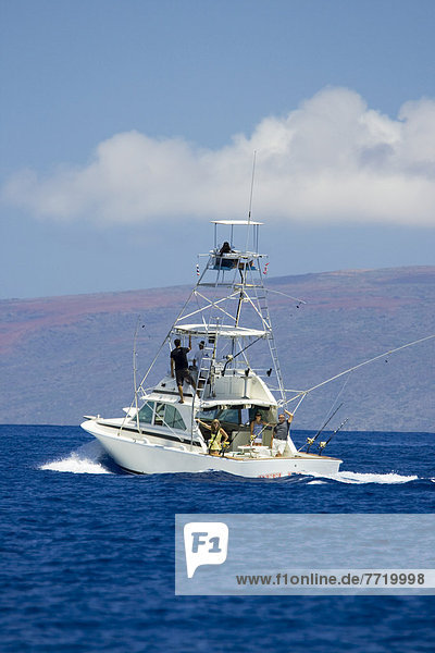 Hawaii  Maui  Sportfishing Boat Cruising In Blue Ocean Water  Kahoolawe In Background.