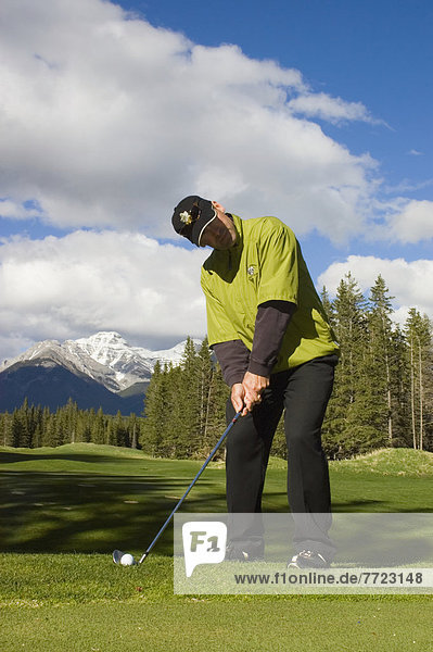 A Man Playing Golf At Banff Springs Hotel Golf Course   Banff National Park Alberta Canada