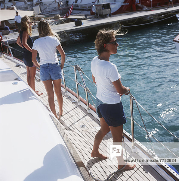 Girls Standing On The Deck Of A Yacht