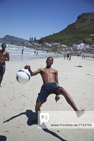Local Boys Playing Football On Beach  Muizenberg  Cape Town  Local Boys Playing Football On Beach  Muizenberg  Cape Town  South Africa
