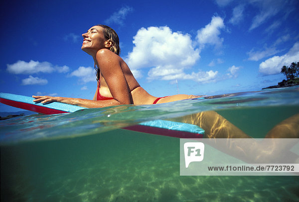 Woman Laying On Boogie Board  Over/Under Shot With Turquoise Water