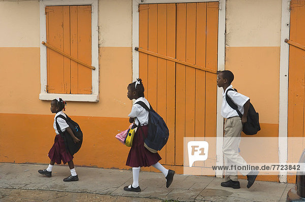 Three Children Walking To School  Carriacou Island In The Grenadines. Grenada. Caribbean.