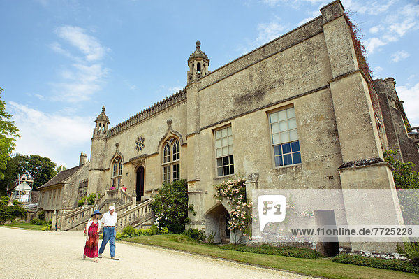 People Walking In Front Of The Lacock Abbey At Lacock  Wiltshire  Uk