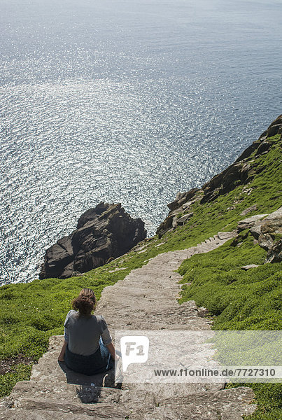 UK  Ireland  County Kerry  Hiker on footpath climbing up Skellig Michael  Skellig Islands