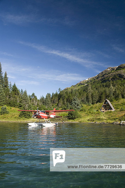 Usa  Alaska  Prince William Sound  Shrode Lake  Float Plane Parked By Us Forest Service Cabin.