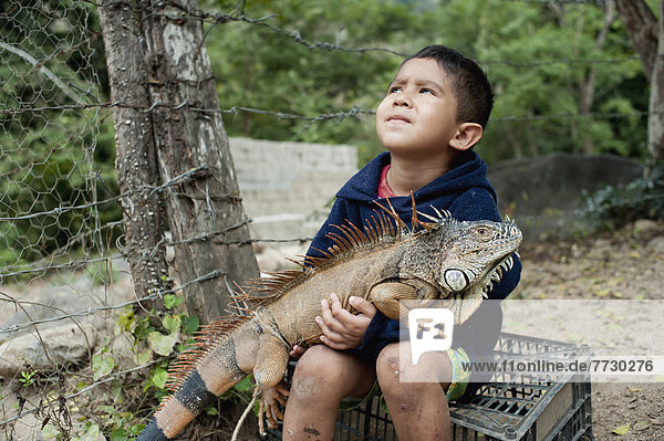 A Young Boy Holds An Iguana On His Lap  Yelapa  Jalisco  Mexico