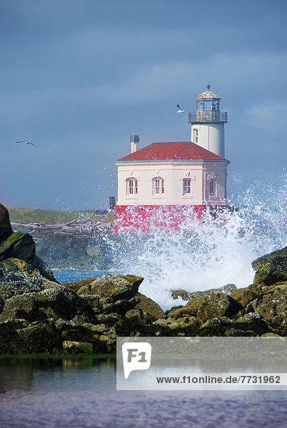 Oregon Lighthouse With Crashing Wave  Bandon Oregon United States Of America