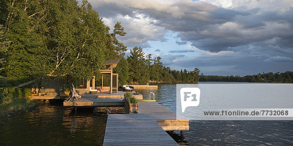 Storm Clouds Over A Lake With Wooden Docks  Lake Of The Woods Ontario Canada
