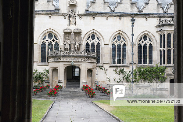 Entrance Of A White Building With Red Flowers Lining The Steps To The Doorway  Oxford England