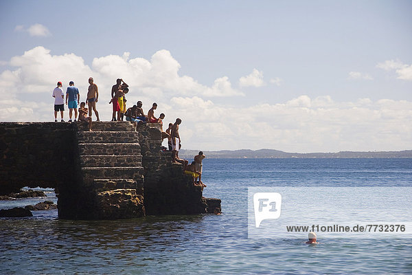 Group of young people on concrete steps  Porto da Barra Beach  Salvador  Bahia State  Brazil