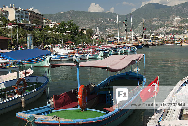 waiting for taking tourist on cruise around harbor  View of fishing boats moored  Alanya  Antalya Province  Turkey