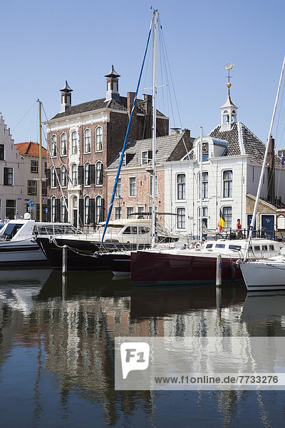 Netherlands  Zealand  Boats in harbour and buildings by waterfront  Goes