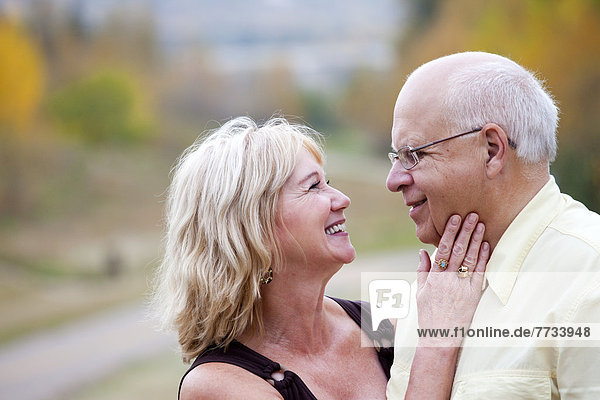 Mature Married Couple Enjoying Spending Time Together In Park During Fall Season  Edmonton  Alberta  Canada