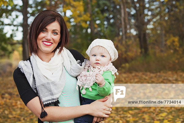 Portrait Of A Mother And Her Baby Daughter In A Park In Autumn  Edmonton  Alberta  Canada