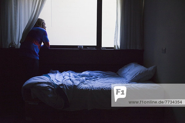 Man Looking Out Of A Bedroom Window Perth West Australia Australia