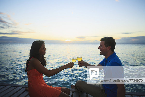 A Man And Woman Give A Toast With Drinks At The Bora Bora Nui Resort And Spa  Bora Bora Island Society Islands French Polynesia South Pacific