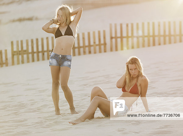 Two teenage girls on the beach  tarifa cadiz andalusia spain