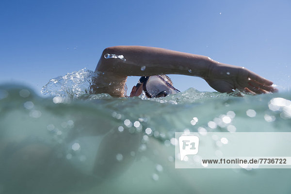 A person swimming with goggles on the surface of the water  tarifa cadiz andalusia spain