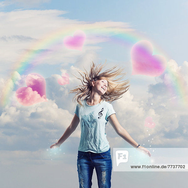 A joyful girl with a dreamy background of hearts in the clouds and twinkles Malaga andalusia spain