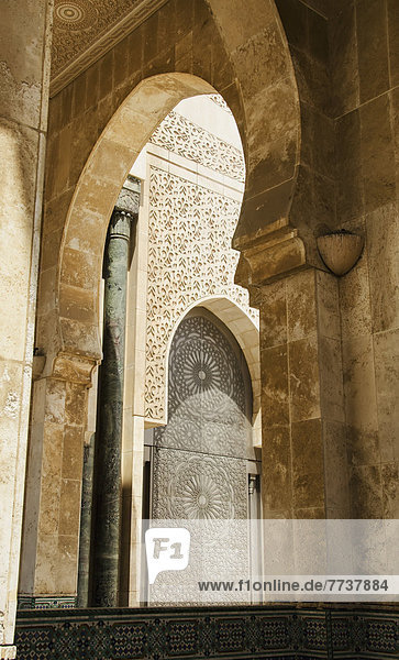 Ornate facade on walls with arches in hassan ii mosque Casablanca morocco