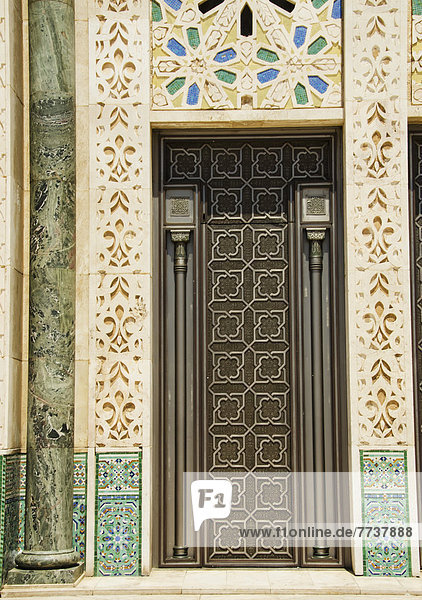 Ornate detail on the wall and door at the hassan ii mosque Casablanca morocco