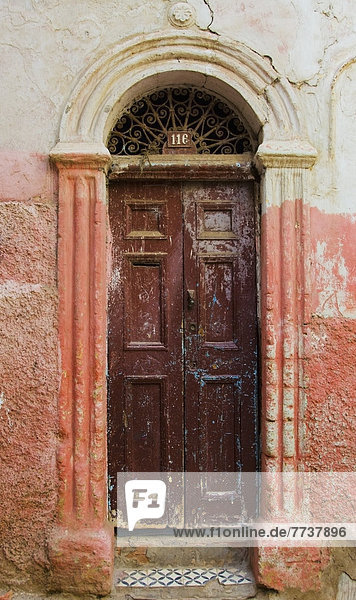 A weathered wooden door and doorframe with old painted walls Casablanca morocco