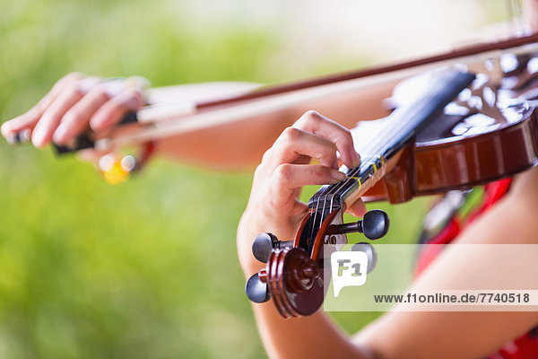 USA  Texas  Young woman playing violin  close up