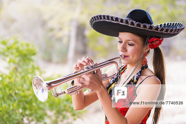 USA  Texas  Young woman playing trumpet