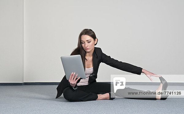 Businesswoman exercising with digital tablet
