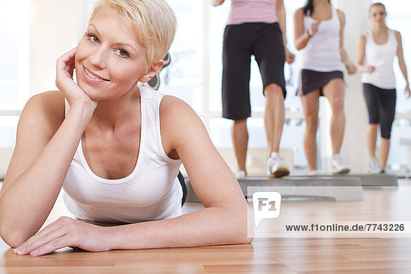 Women doing exercise in gym  smiling
